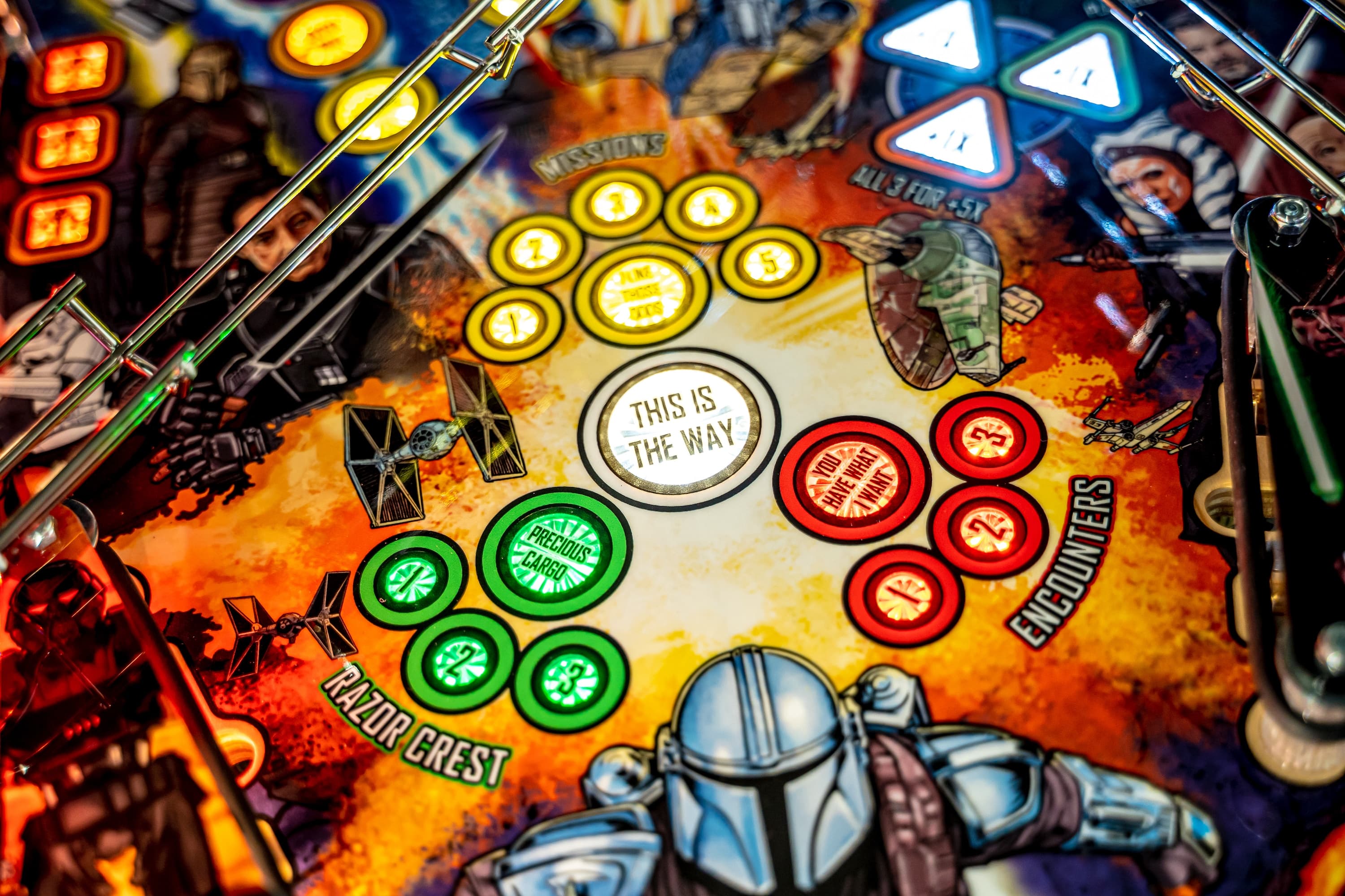 Star Wars Mandalorian pinball machine playfield with colorful game tokens