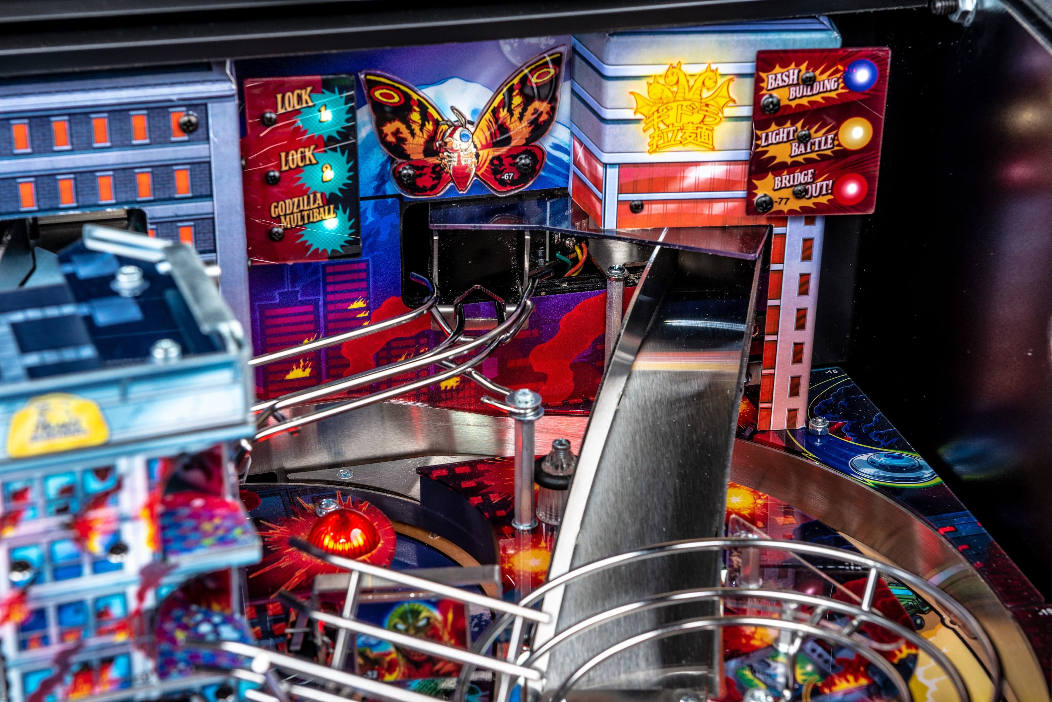 Godzilla pinball machine with colorful artwork and metal ramps