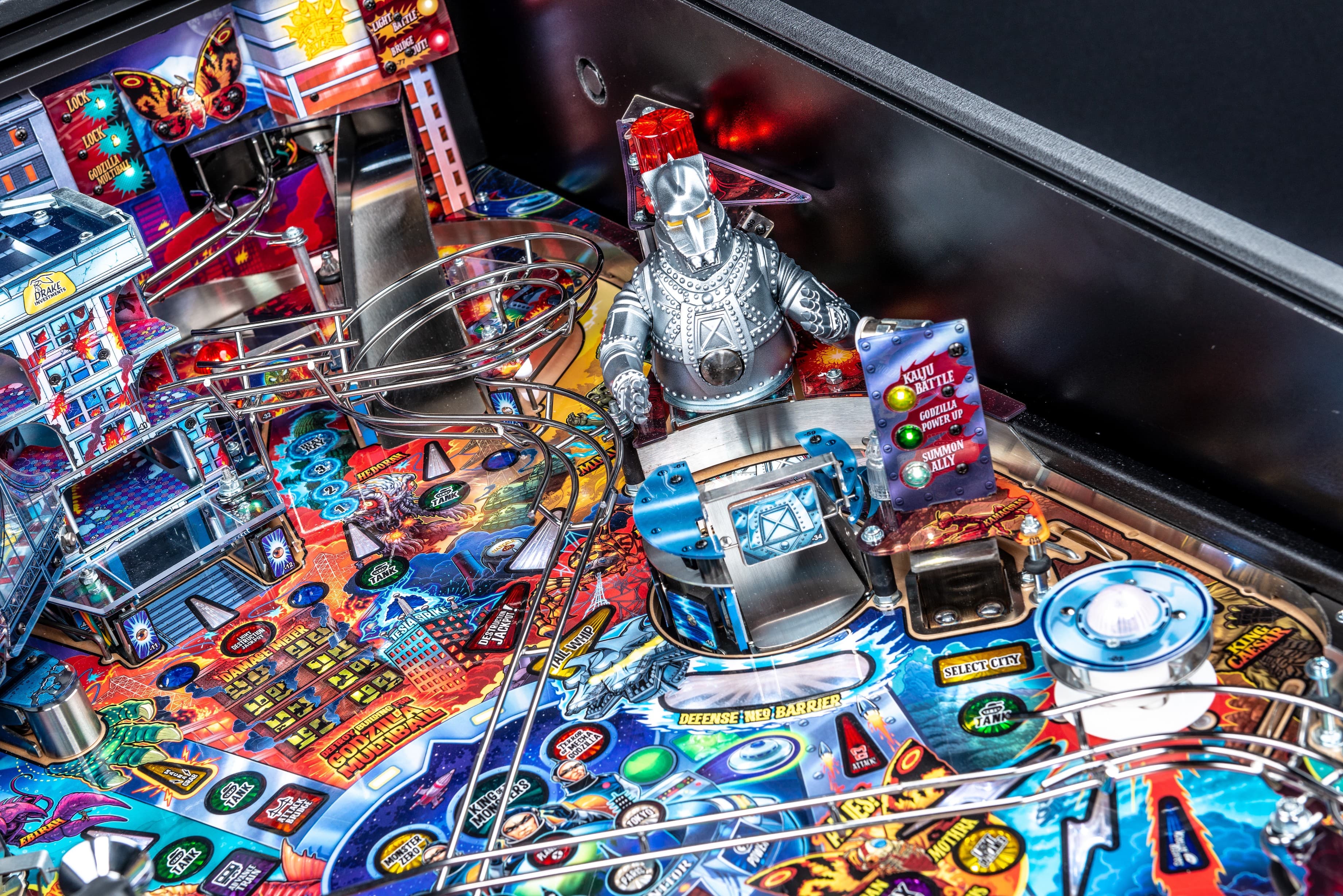 Colorful Godzilla-themed pinball machine with intricate design and metal knight