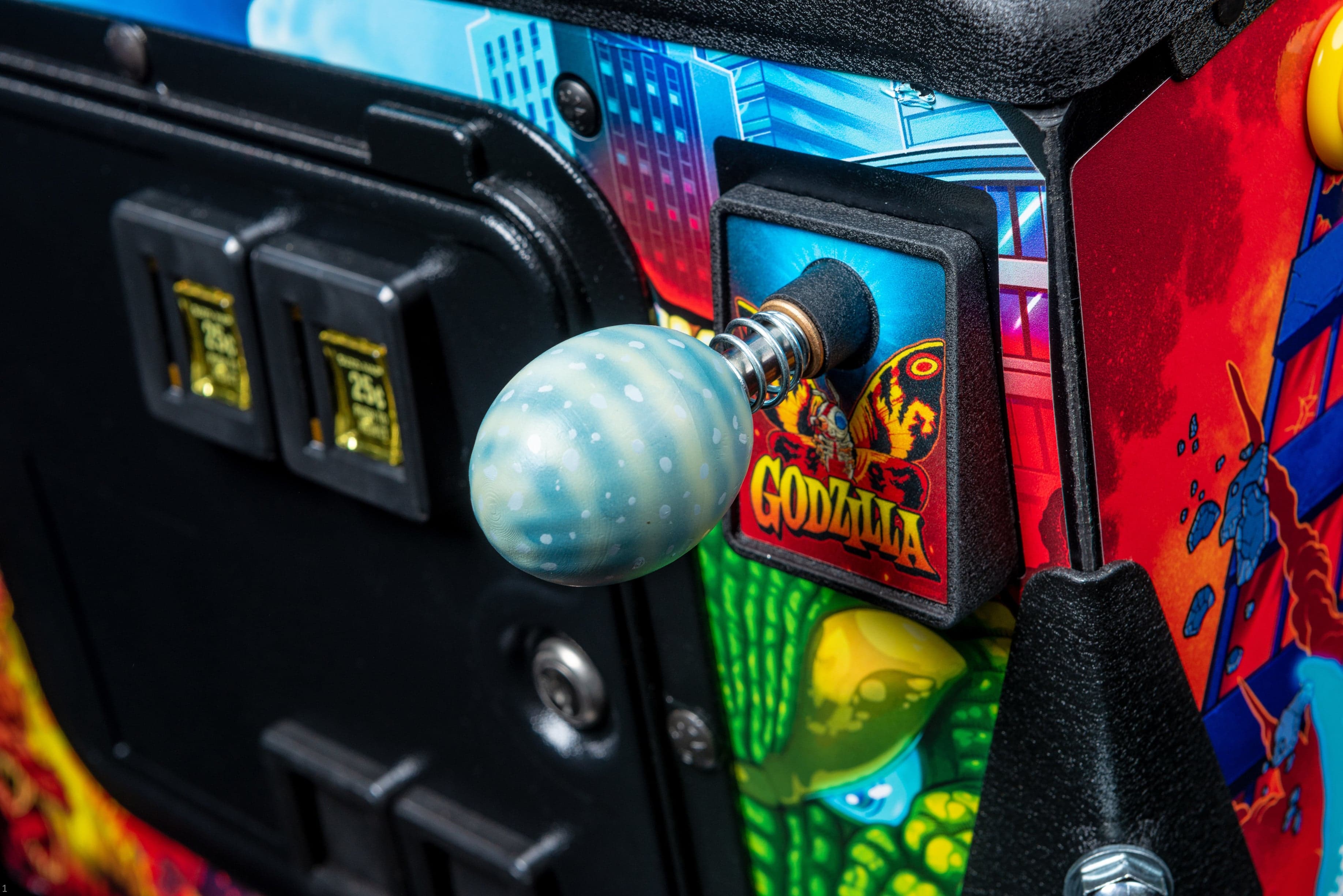 Godzilla arcade game with blue polka dot joystick ball closeup