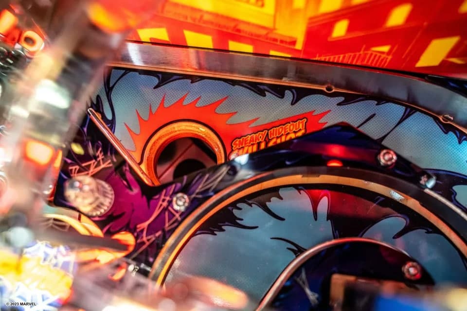 Close-up of colorful pinball machine with vibrant red and blue details