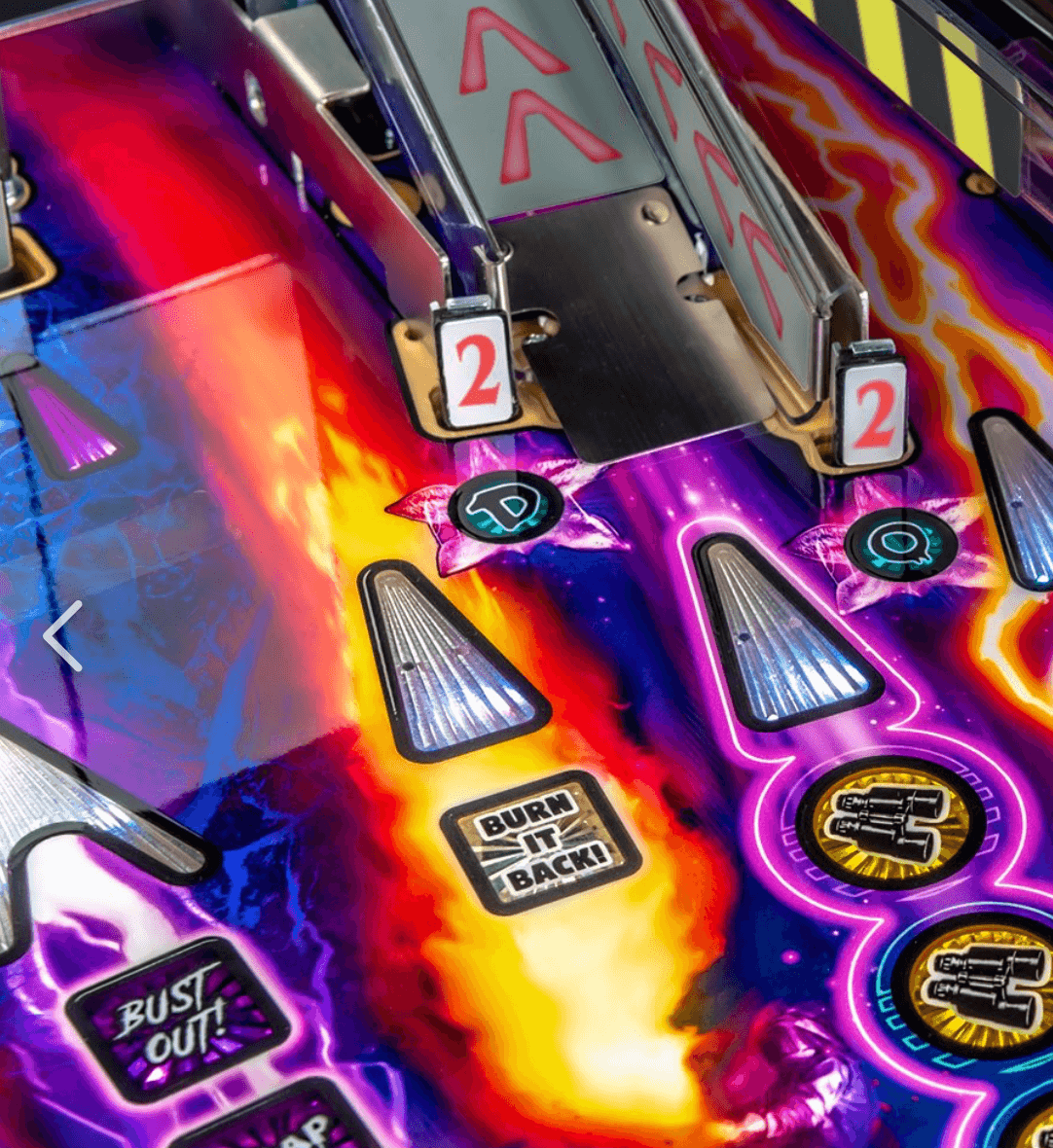 Colorful pinball machine playfield with fiery flames and neon graphics
