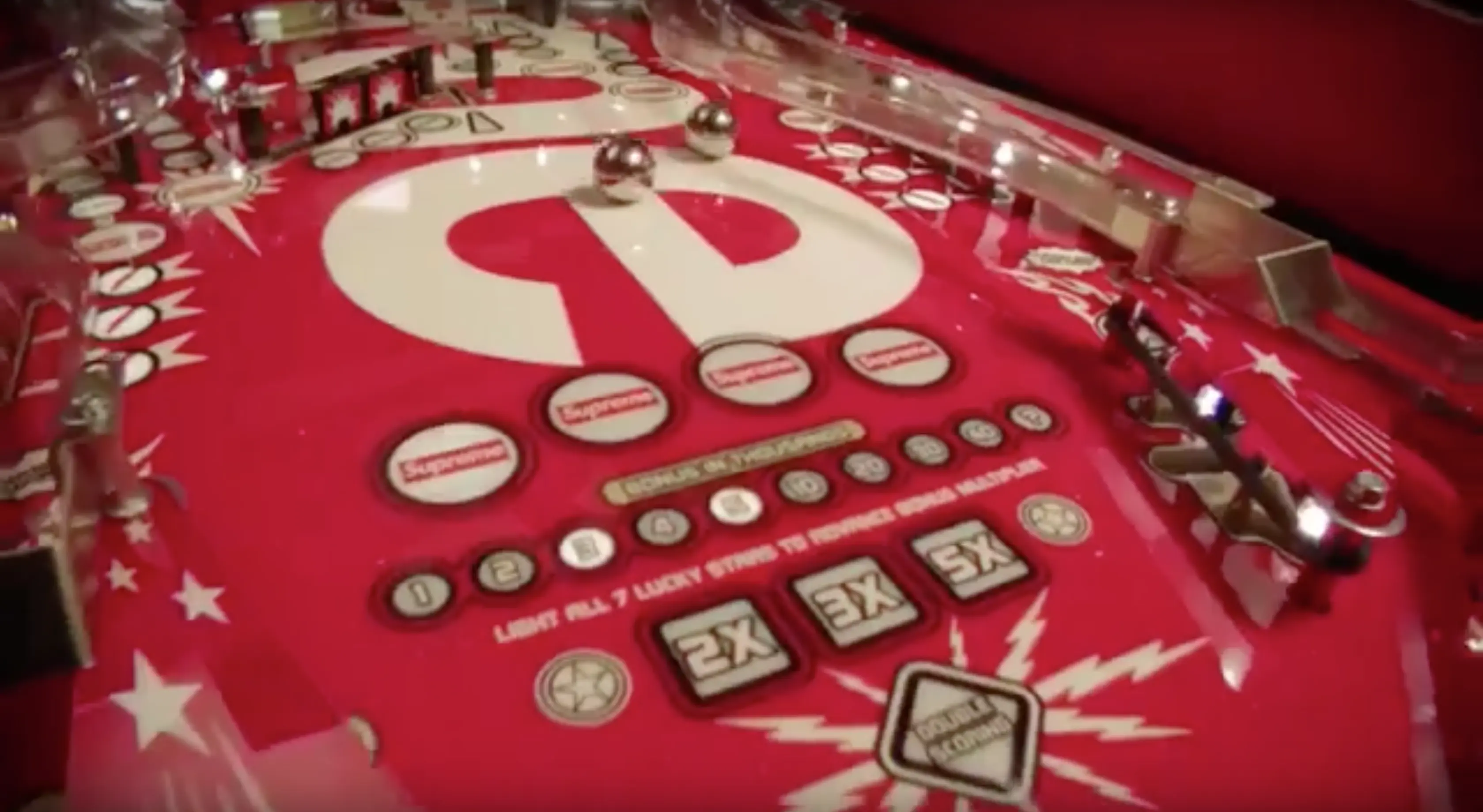 Vintage pinball machine with red playfield and white stars