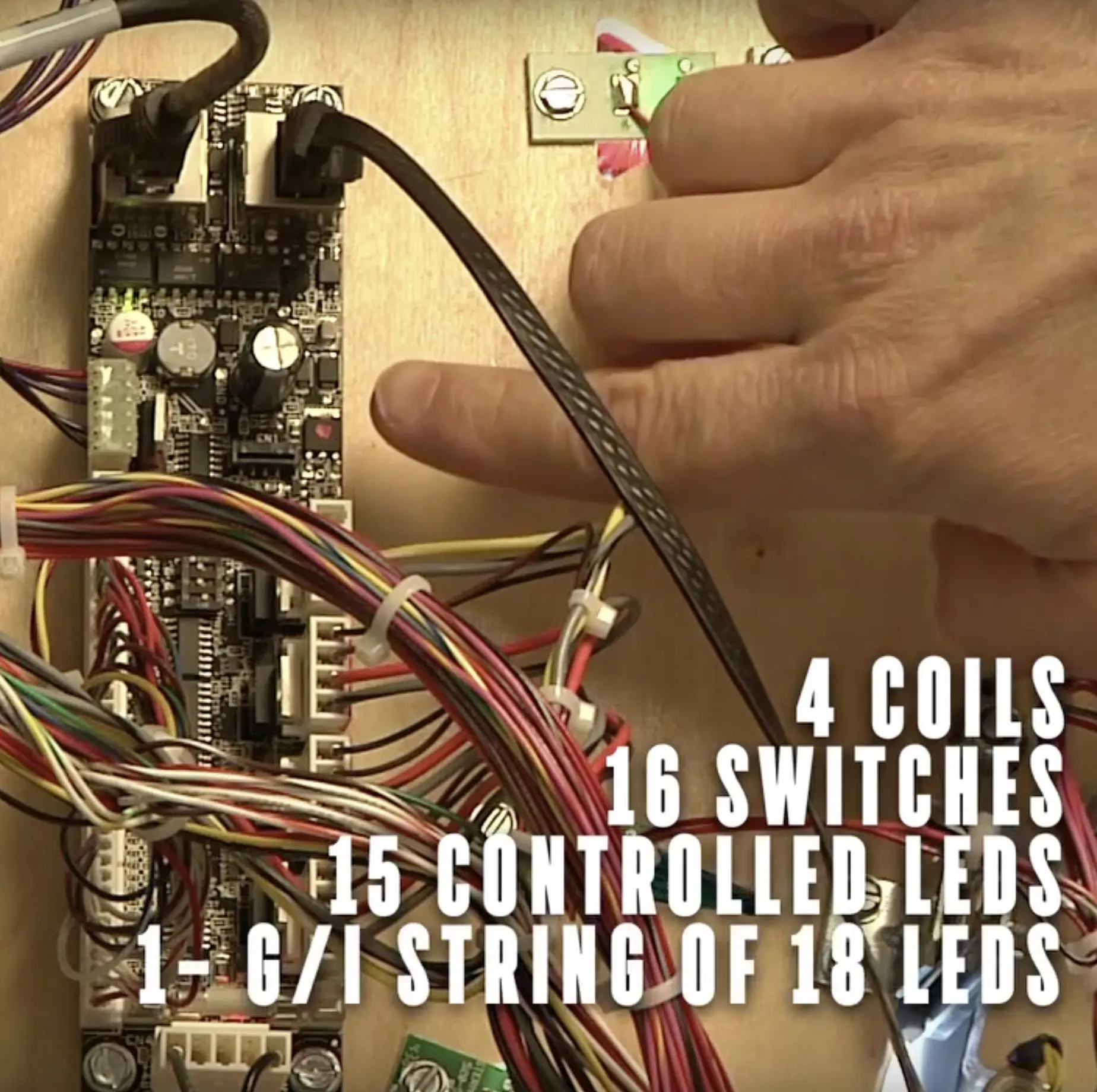 Electronic circuit board with colorful wires, coils, switches, and LEDs