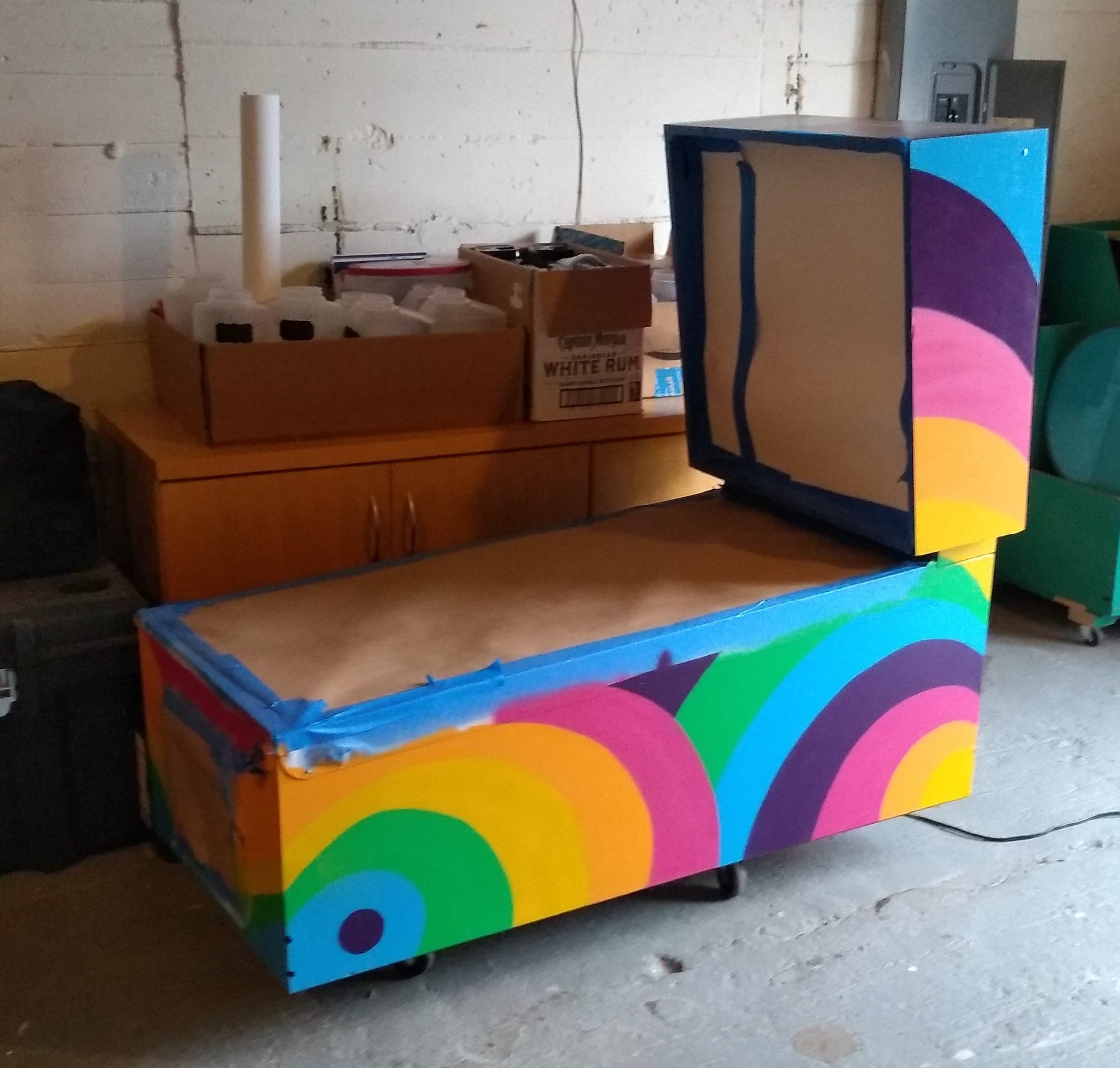 Colorful storage chest with retro rainbow circles in workshop