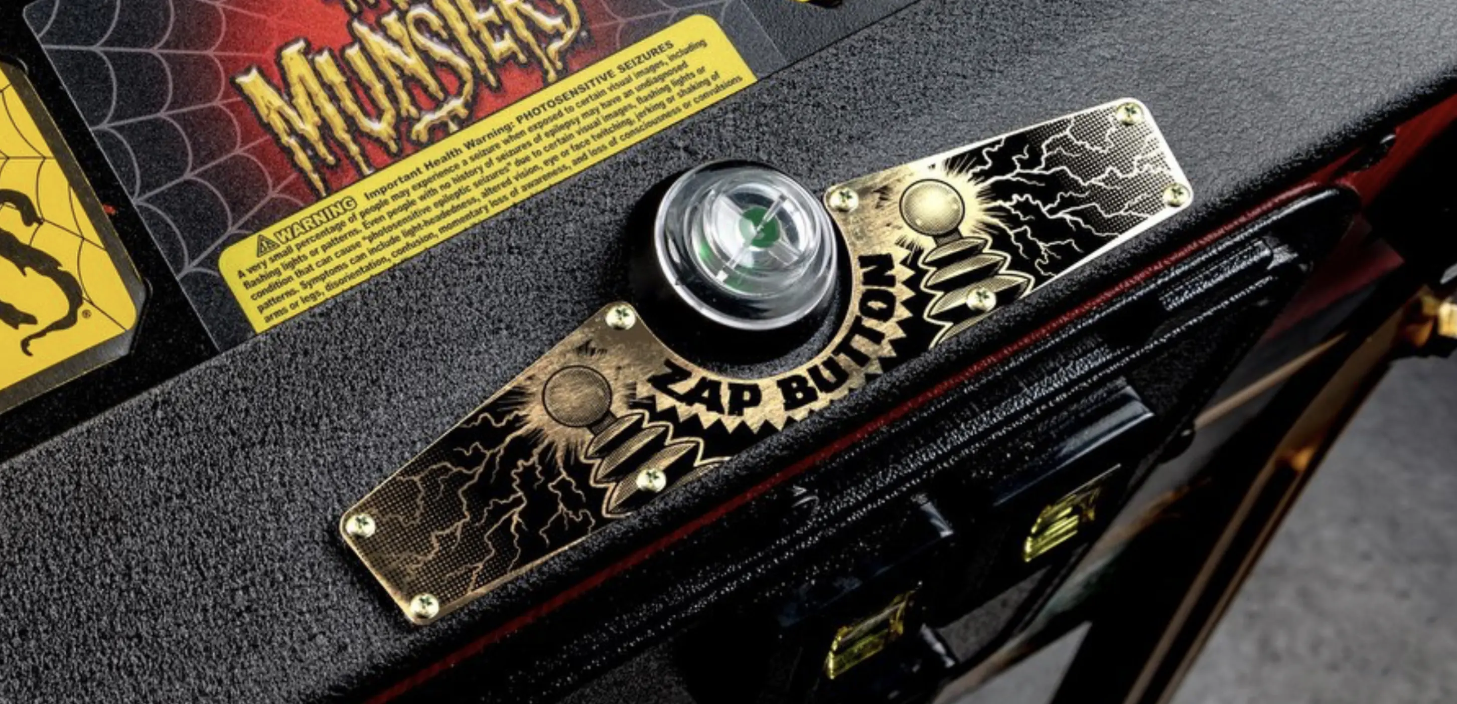Monsters pinball machine detail with zap button and warning label