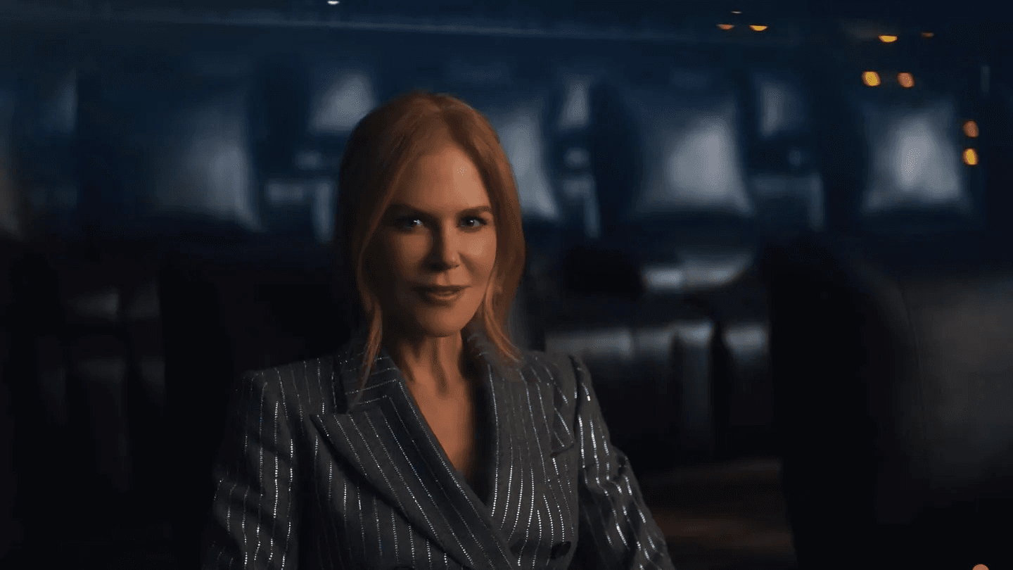 Woman in silver pinstripe blazer standing in dark urban setting