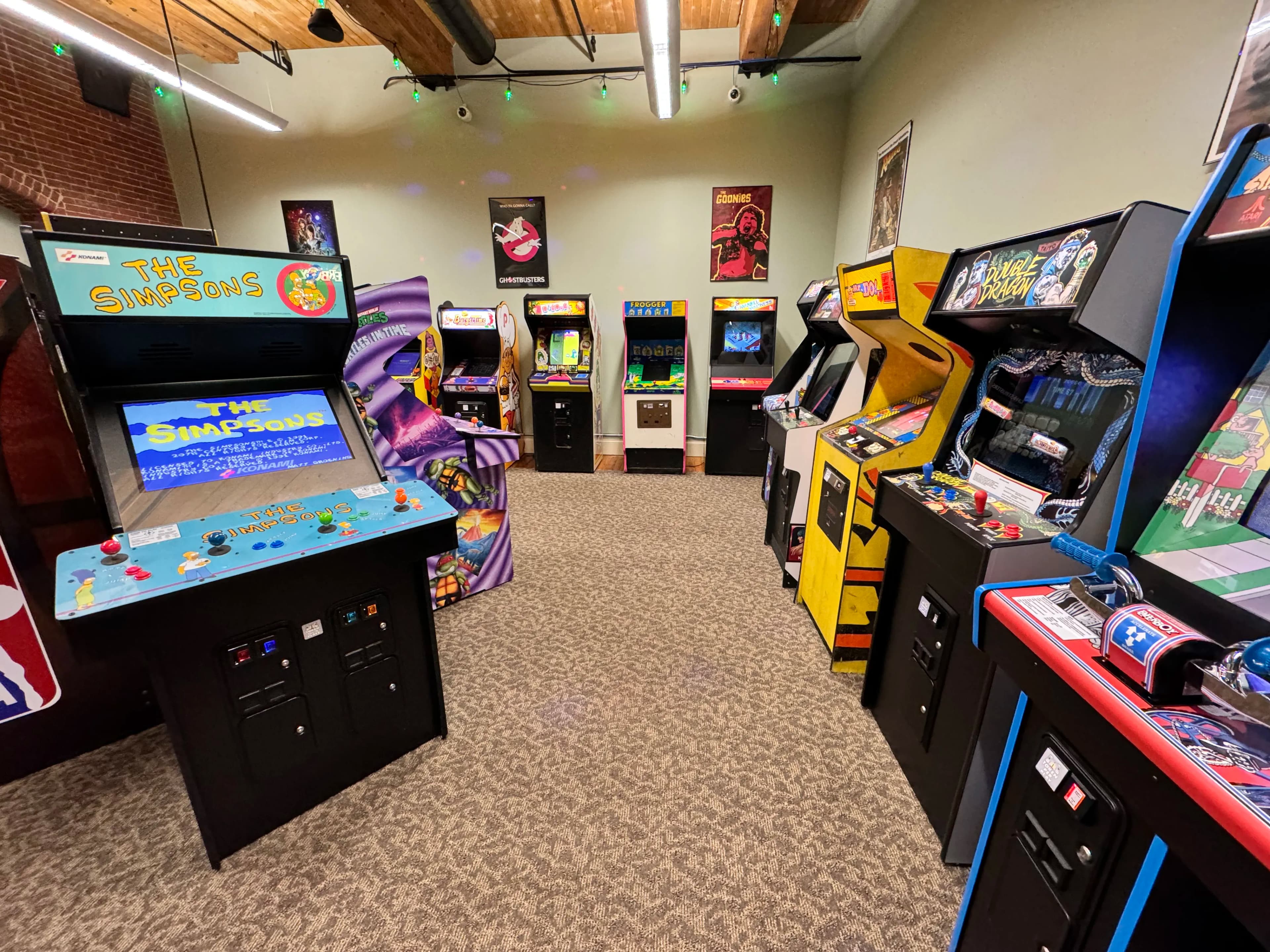 Vintage arcade room with classic game cabinets and movie posters