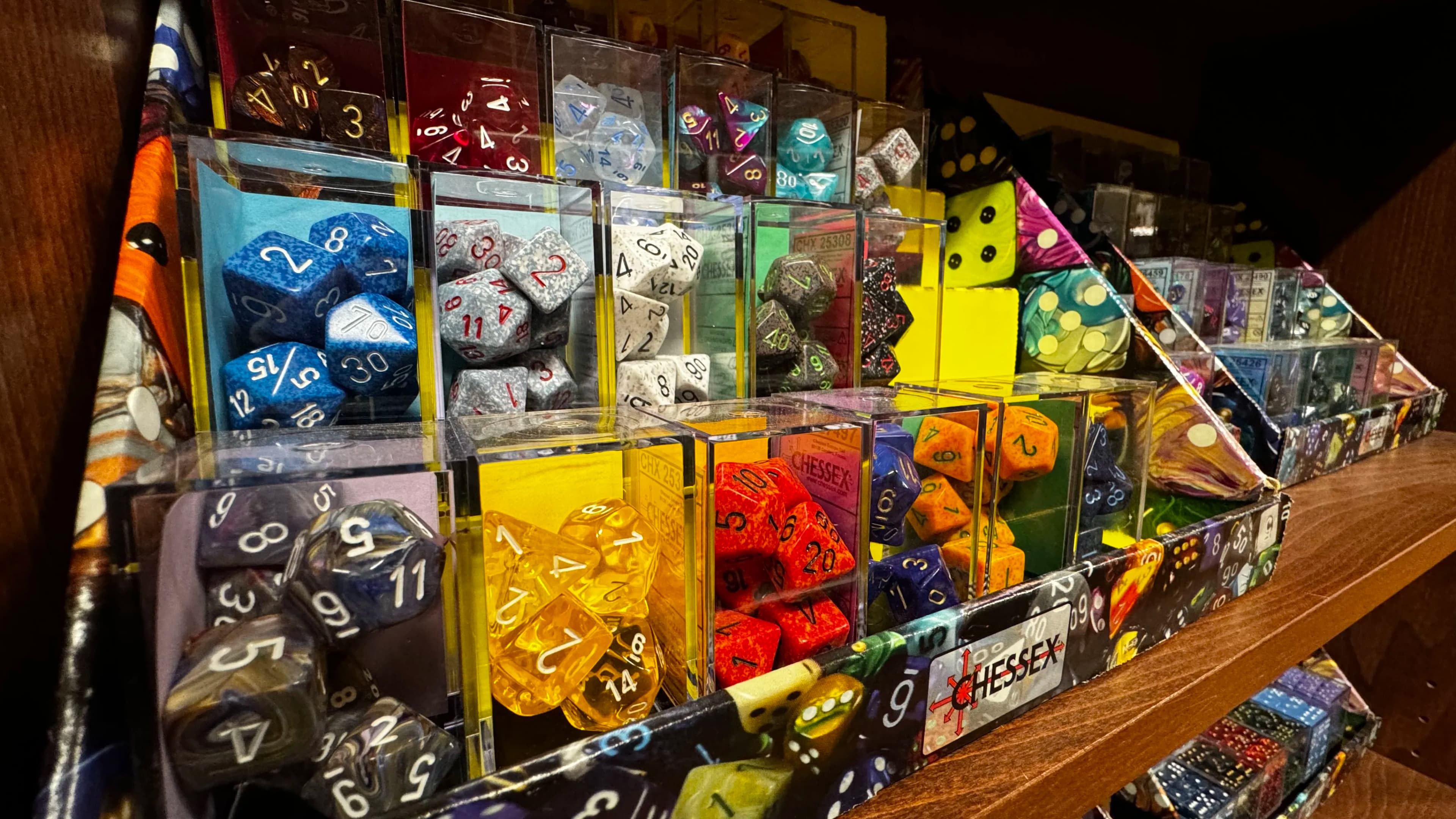 Colorful polyhedral dice display in various sizes and transparent cases