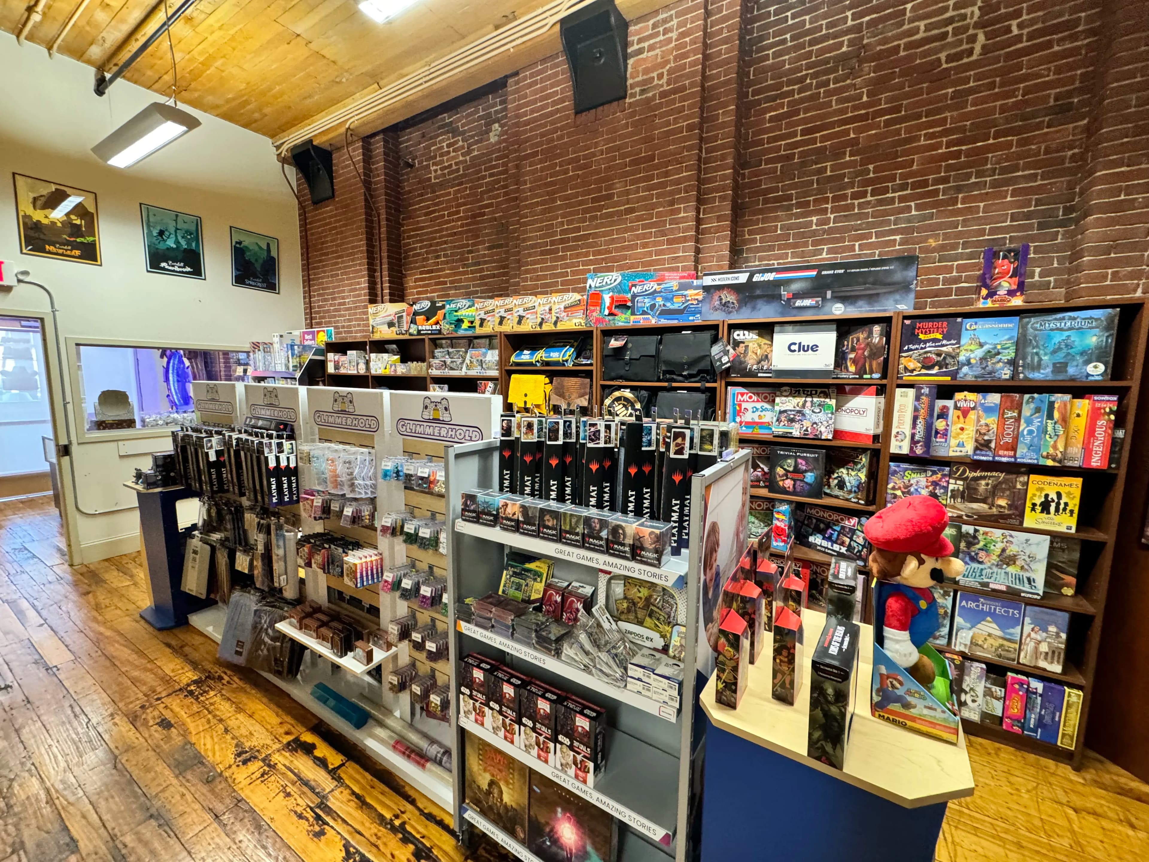 Game store interior with board games, Magic cards, and Mario figure