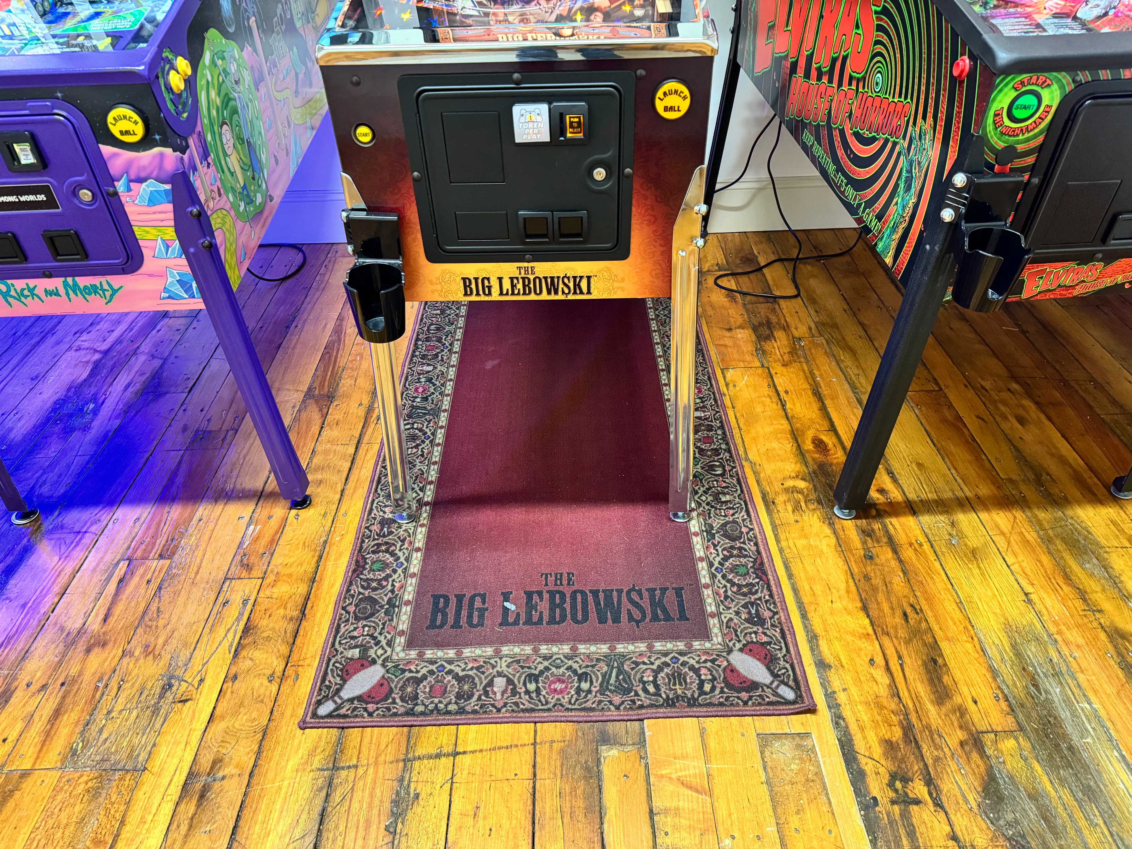 The Big Lebowski themed pinball machine with ornate rug and colorful sides