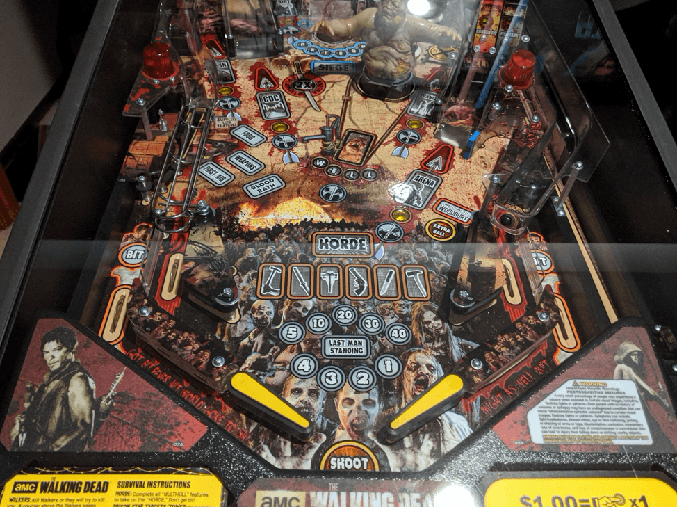 Walking Dead pinball machine with zombies, targets, and gameplay elements