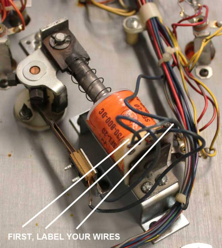 Close-up of electronic components with colorful wires and an orange capacitor