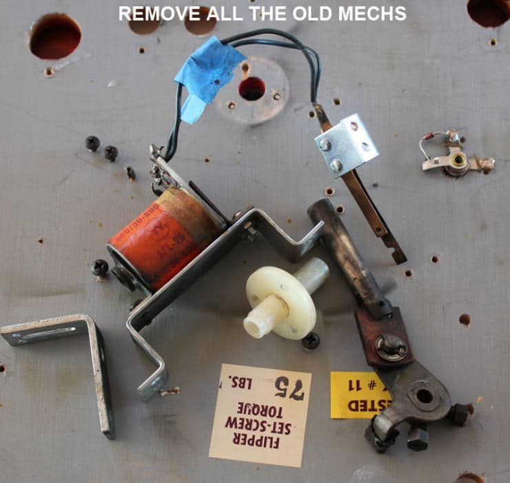 Disassembled mechanical parts with screws, wires, and metal components