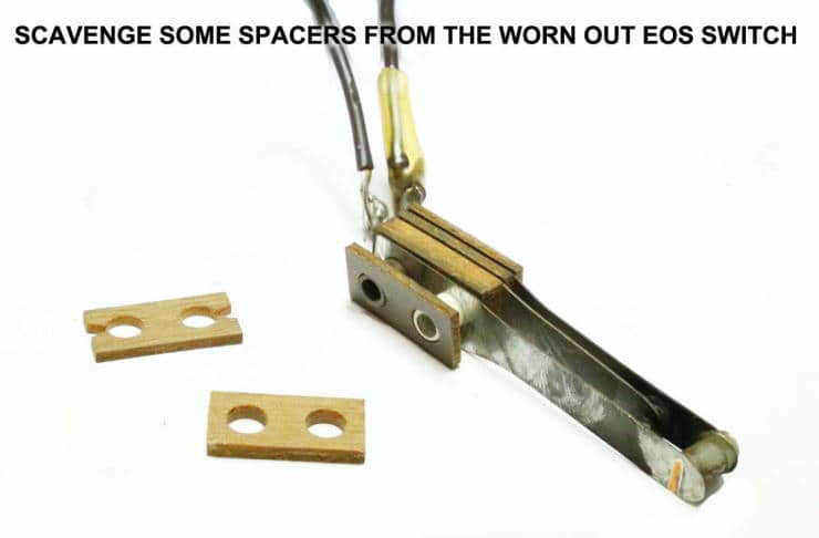 Worn out EOS switch with metal mechanism and wooden spacer blocks