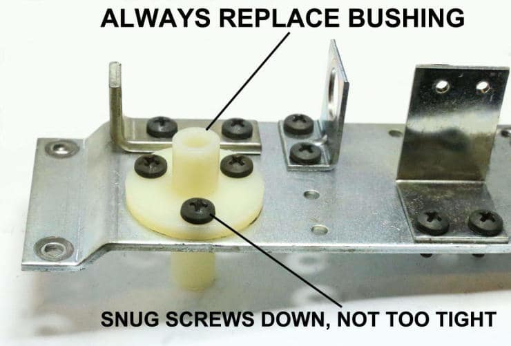 Metal mounting plate with white bushing and black screws, maintenance instructions shown