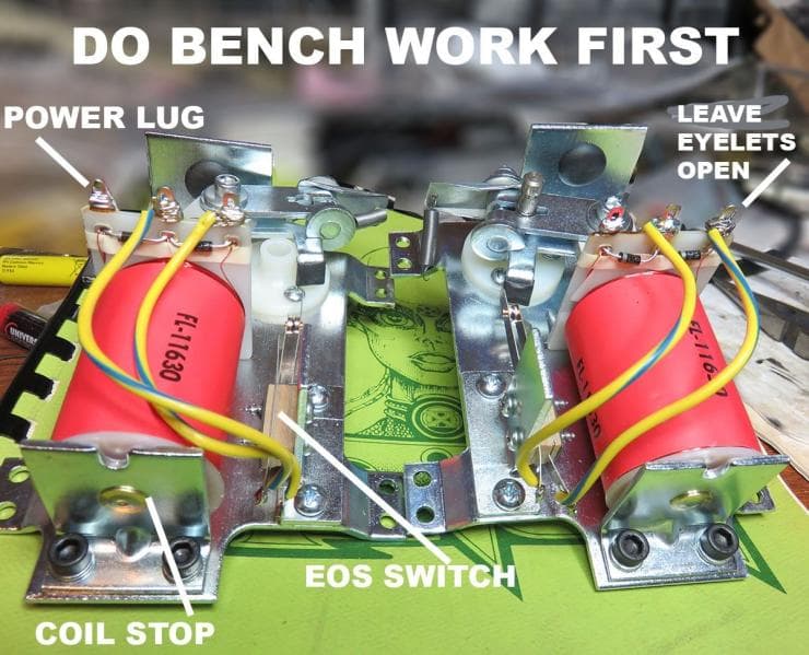 Electronics workbench with labeled components and red capacitors
