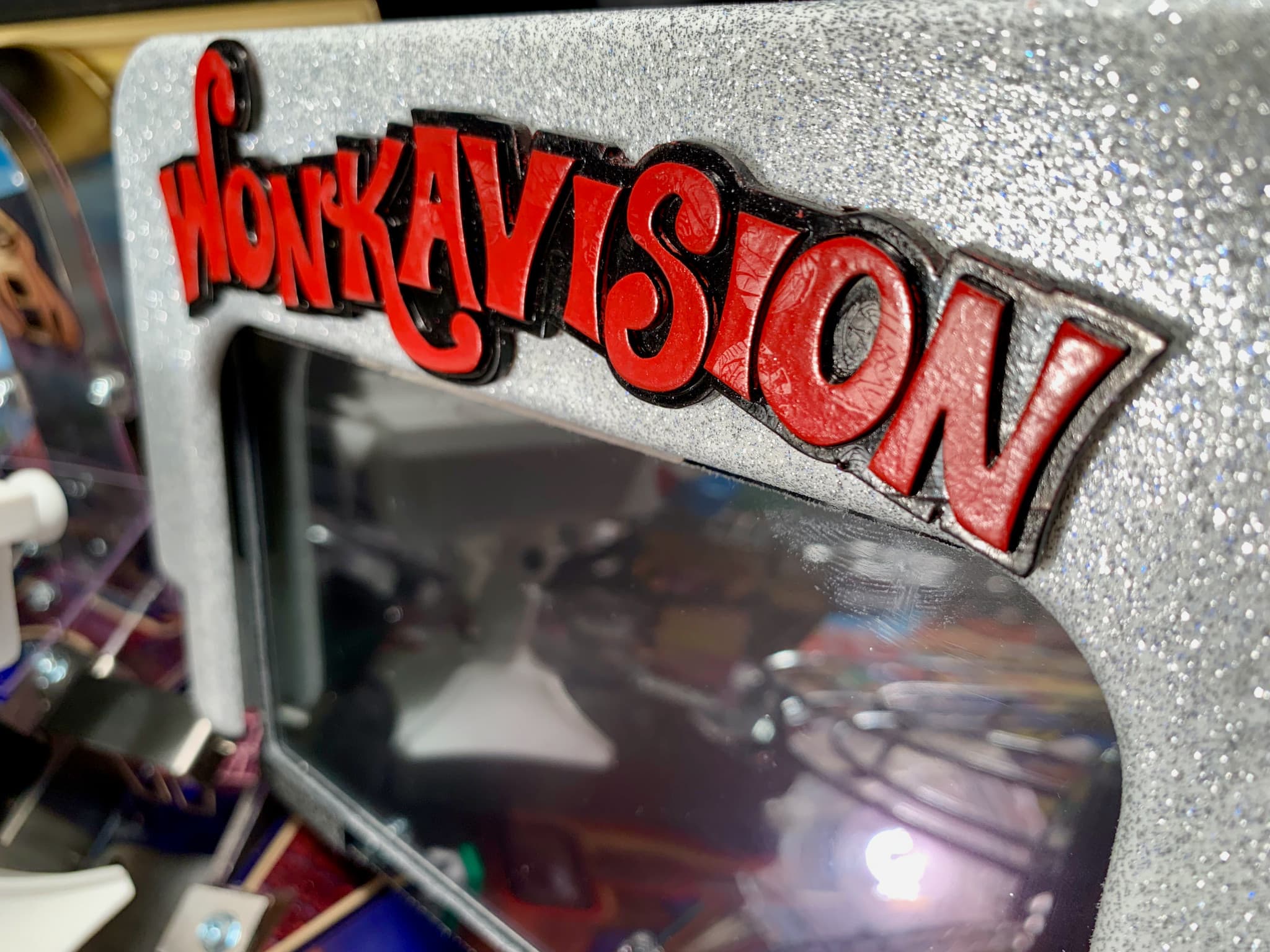 WandaVision logo on glittery silver background with blurred reflection